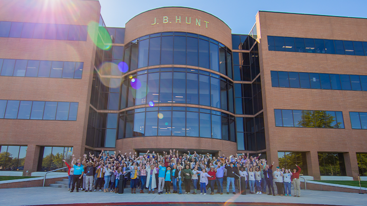 Photo of J.B. Hunt employees in front of J.B. Hunt building