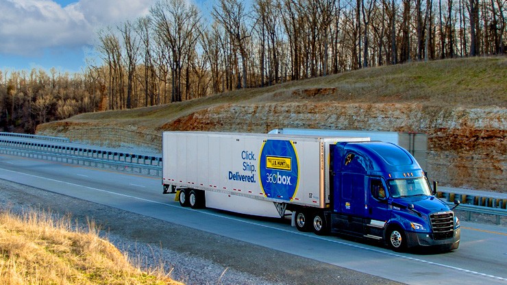 A truck hauling on J.B. Hunt 360box container on the road. 