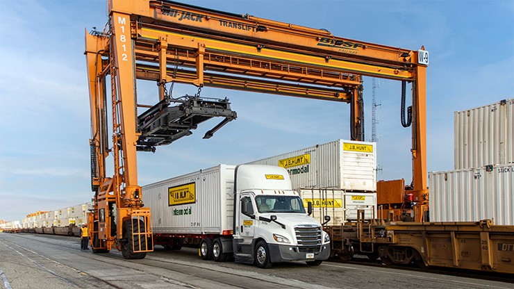 J.B. Hunt intermodal containers being loaded onto a truck