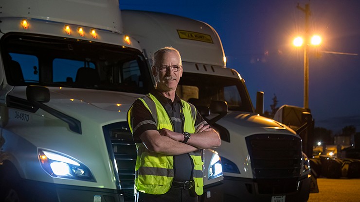driver in front of truck wearing high vis vest driver in front of truck wearing high vis vest