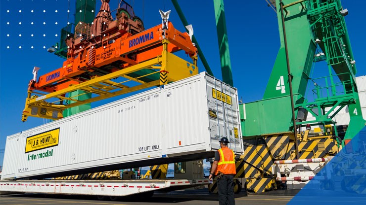 a crane lifts a J.B. Hunt Intermodal shipping container off of its flatbed trailer