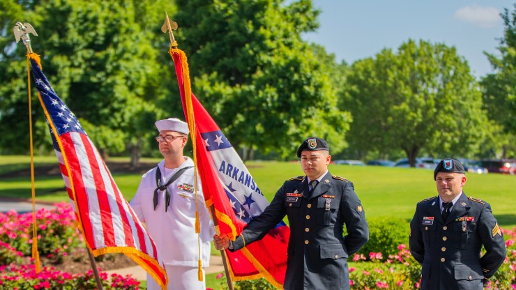 Photo of veterans holding American and Arkansas flag