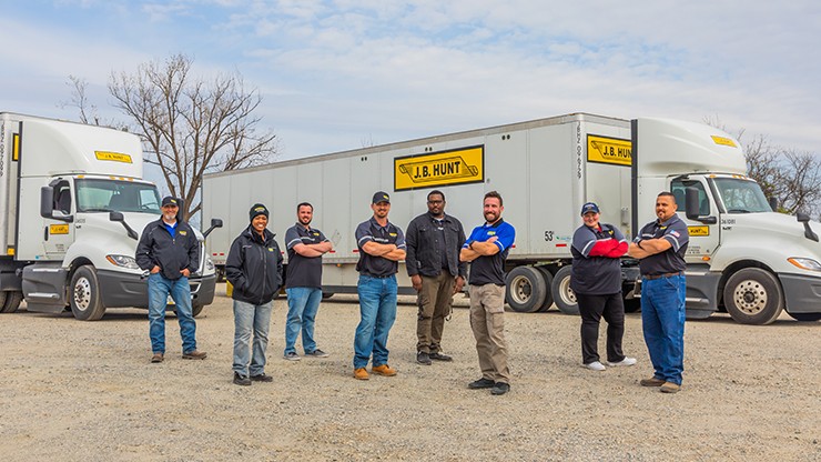 Photo of truck drivers standing in front of J.B. Hunt truck