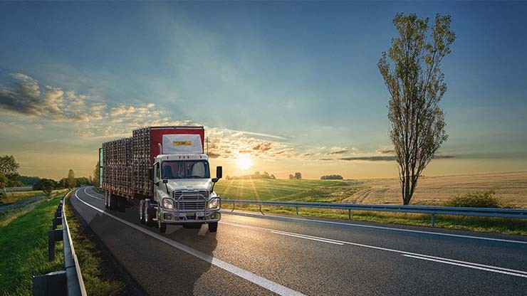 ag truck driving away sunset