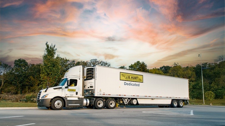 JB Hunt Dedicated Semi-Truck at Sunset JB Hunt dedicated transportation semi-truck parked roadside at sunset for temperature-controlled shipping.