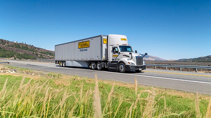 dedicated contract services truck driving on highway