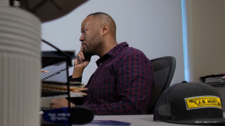 A logistics team working together in an office setting, representing managed logistics solutions for businesses.