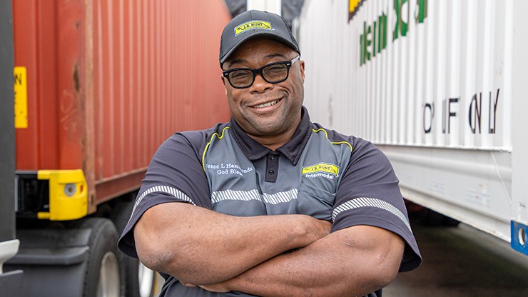 J.B. Hunt driver in between intermodal equipment.