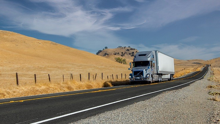 truck driving through rural hills on highway truck driving through rural hills on highway