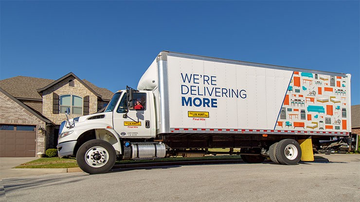 j.b. hunt final mile home delivery truck in front of house