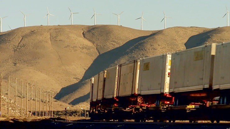 intermodal rail going by windmills