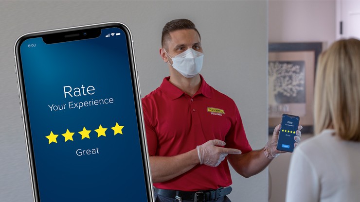 A final mile driver points at a cell phone with rating system