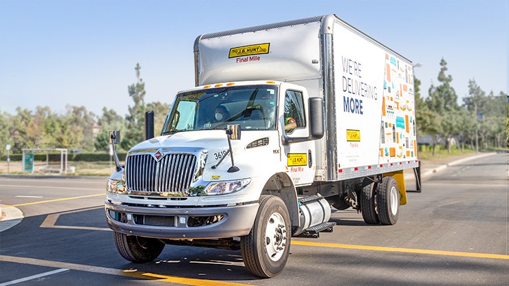 A J.B. Hunt Final Mile straight truck is parked in a parking lot on a sunny day