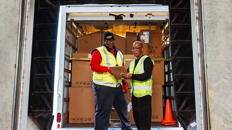 guys reviewing paperwork at loading dock