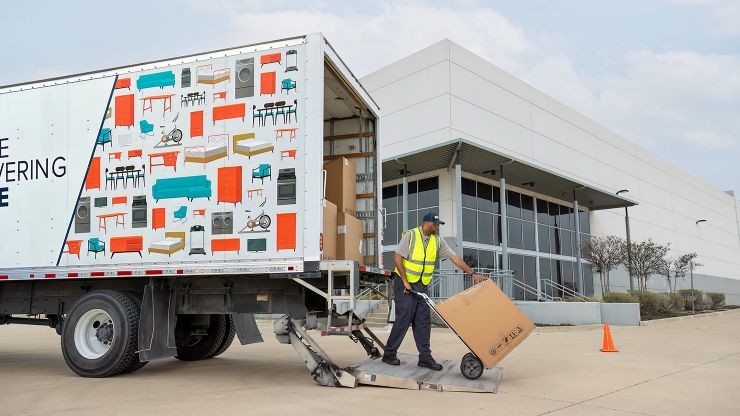 FMS worker delivering box to business
