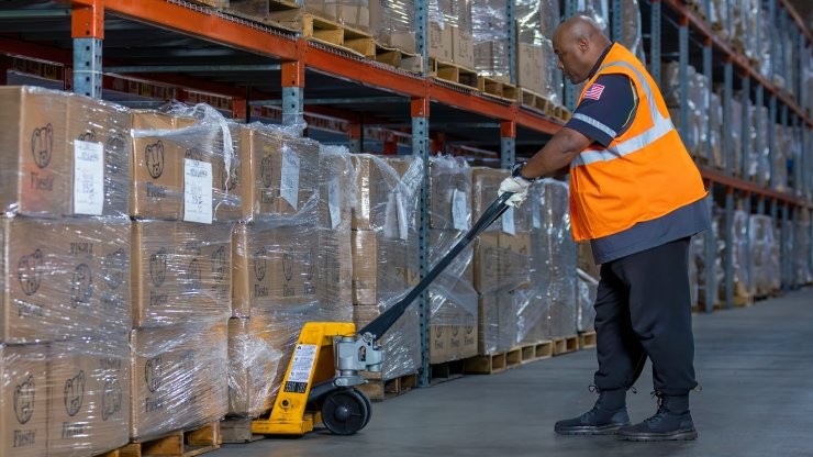 Warehouse employee prepping cargo for an LTL shipment 
