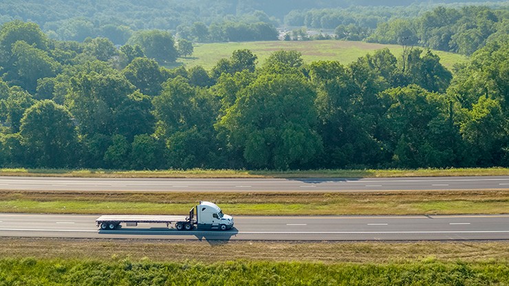flatbed wide shot flatbed truck and trailer on a highway