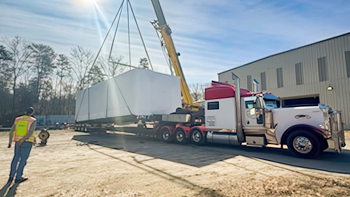 crane loading onto a flatbed truck