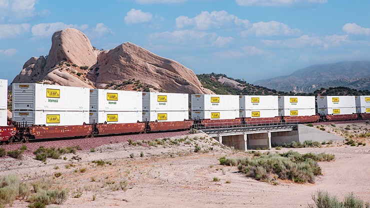 j.b. hunt intermodal containers on train going through a desert environement 