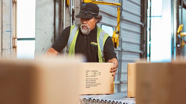 man moves box on conveyor Man moves box on conveyor