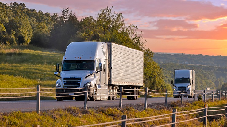 two trucks on a rural highway two trucks on a rural highway
