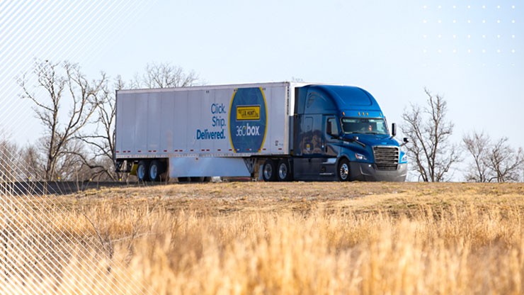 A J.B. Hunt 360box tractor trailer is parked on top of a hill