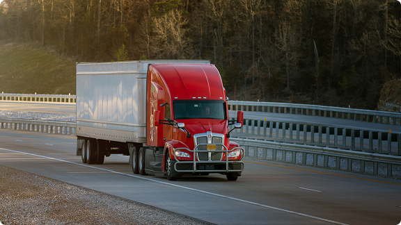 red truck driving down the highway