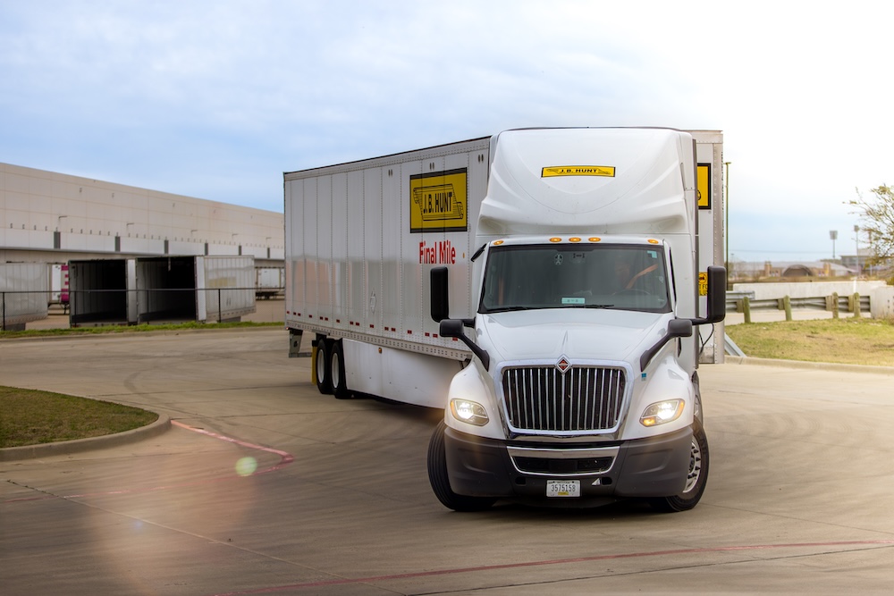 J.B. Hunt Final Mile semi-truck near warehouse facility, illustrating freight transport and logistics operations
