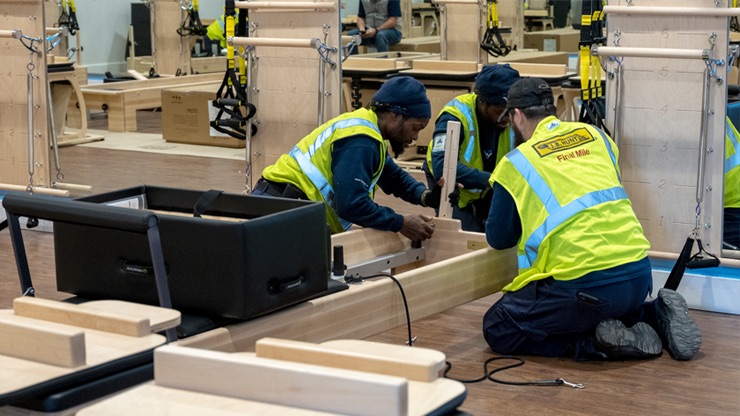 final mile employees setting up fitness equipment