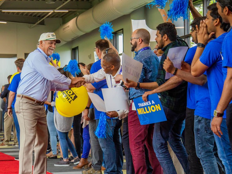 driver shaking the hands of j.b. hunt employees during a walk of fame event