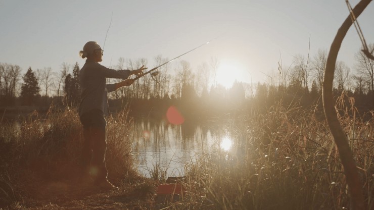 man fishing on a lake