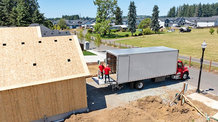 j.b. hunt employees delivering windows to jobsite