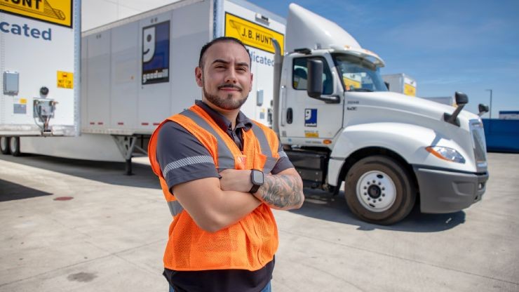 dedicated driver posing in front of goodwill truck