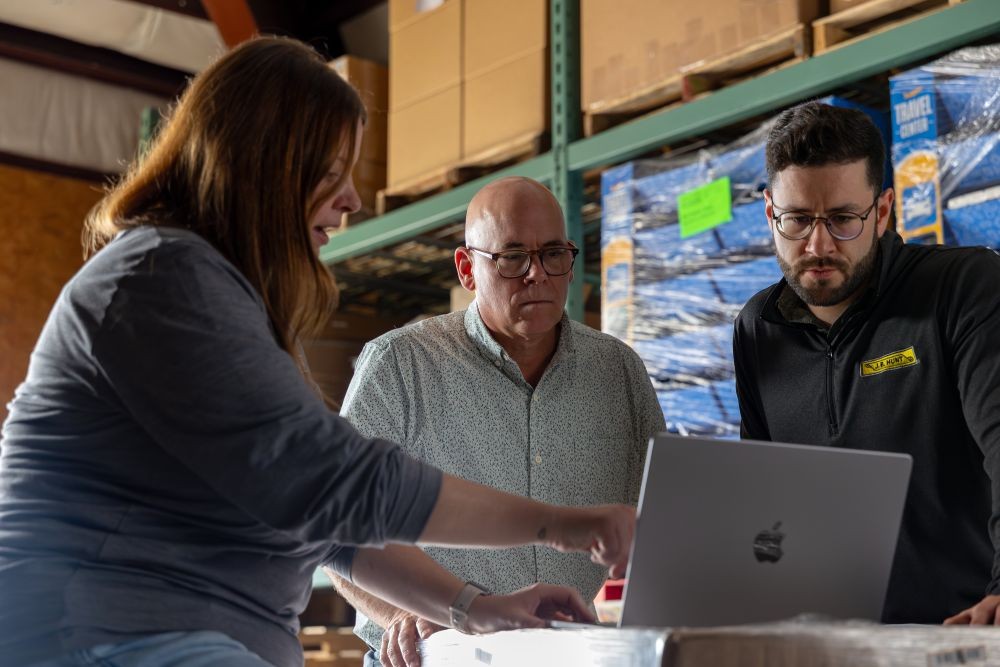going through presentation with customer in a warehouse