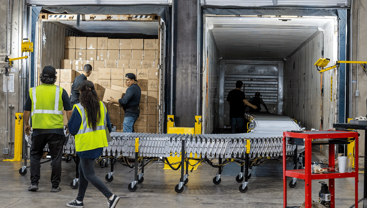 Warehouse employees unloading boxes from a truck