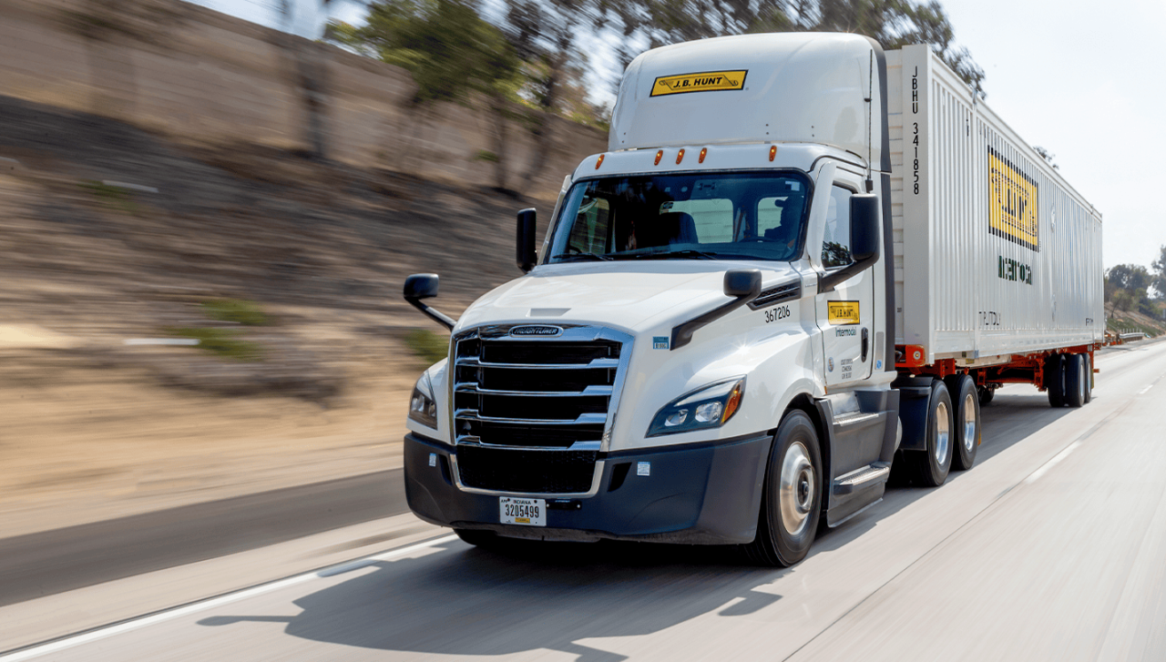 J.B. Hunt intermodal truck transporting a shipping container down a highway