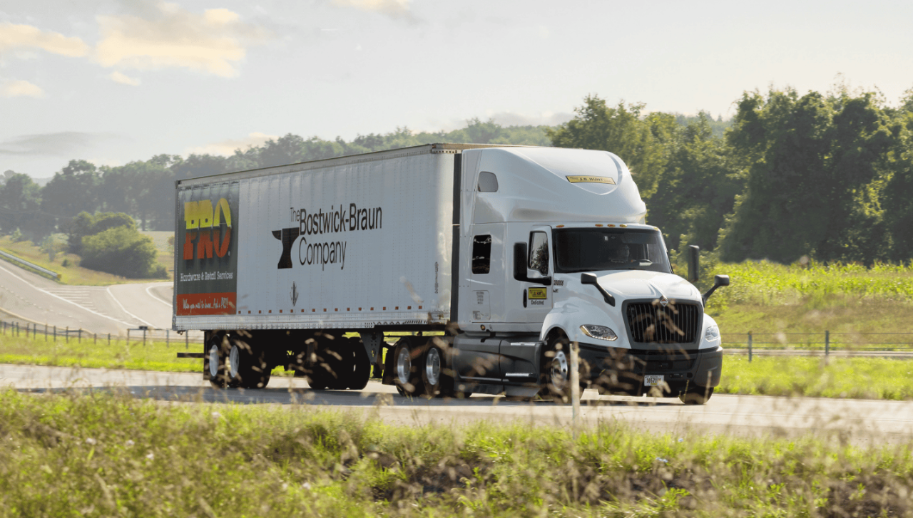 A Bostwick-Braun j.B. Hunt DCS truck drives down a highway