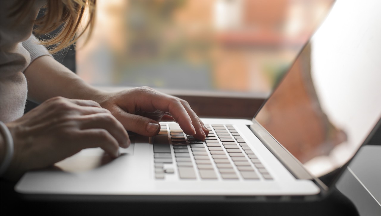 Close-up view on woman who working on laptop