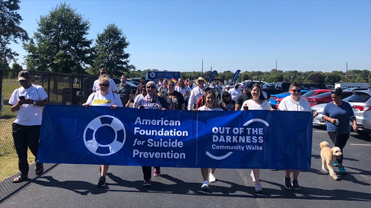 American Foundation for Suicide Prevention march with banner