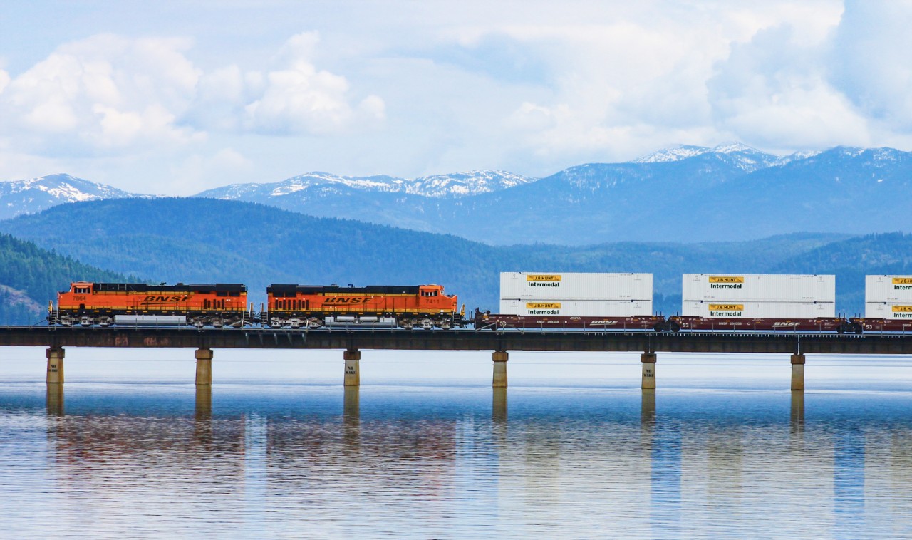 BNSF locomotive with 3d hunt containers crossing lake
