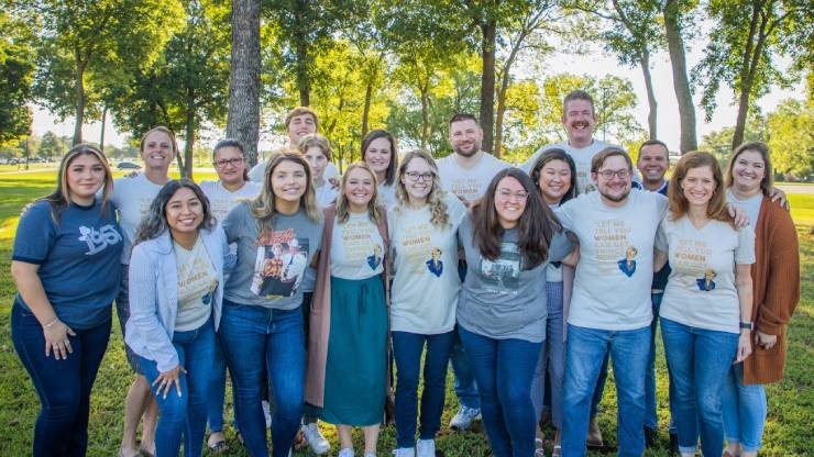 group photo of employees standing outside