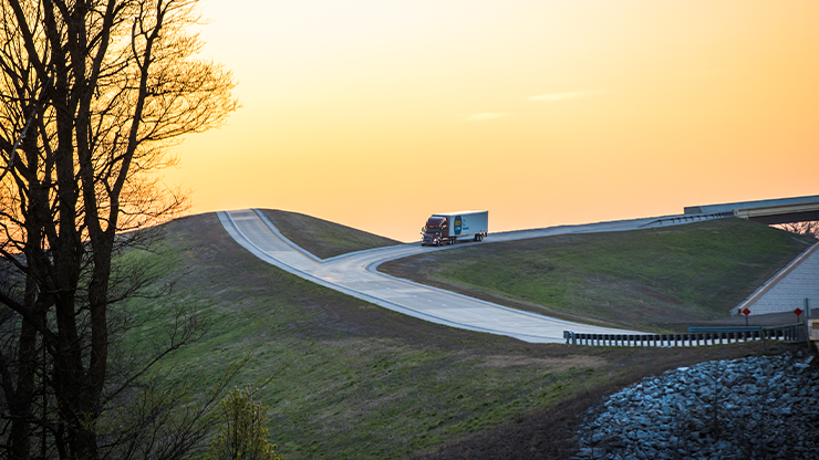 truck driving down a hilly off ramp truck driving down a hilly off ramp