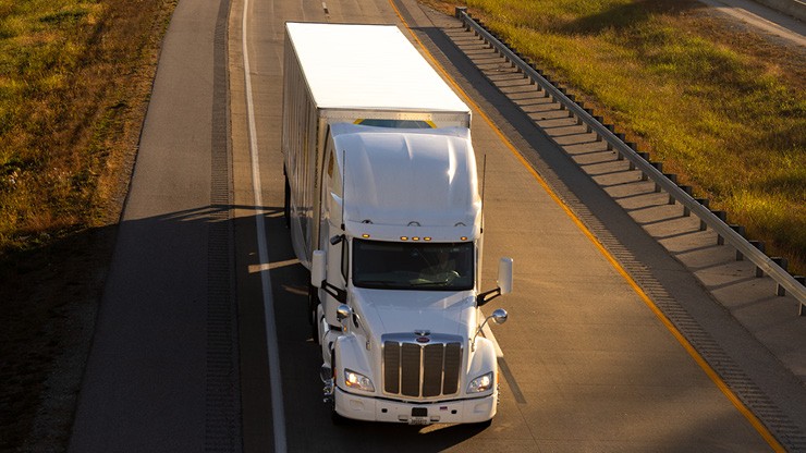 truck driving on a road from bird's eye perspective