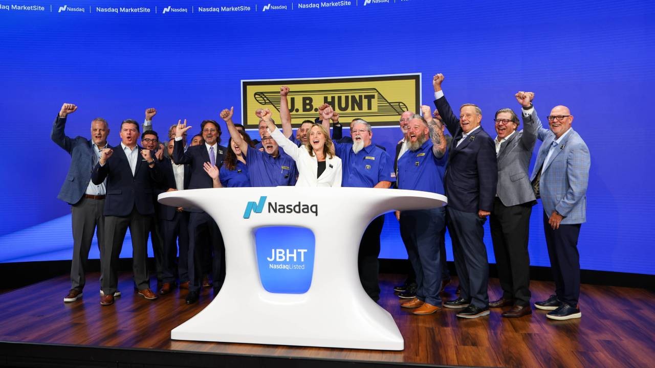J.B. Hunt leaders and longtime employees mark the 65th anniversary of the company at a Nasdaq Opening Bell ceremony in New York City. The group included drivers, maintenance technicians, office employees and executives whose service spans multiple decades of the company's history.
