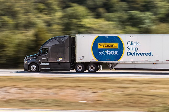 Truck hauling a J.B. Hunt 360box® trailer on the highway. 