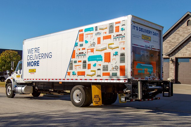 A J.B. Hunt Final Mile Services® truck parked in front of a house.