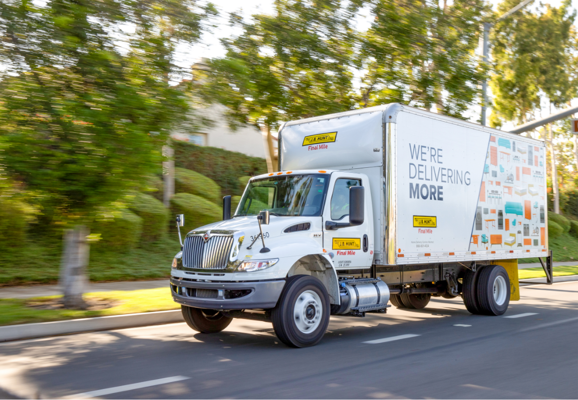 final mile straight truck driving down a residential street