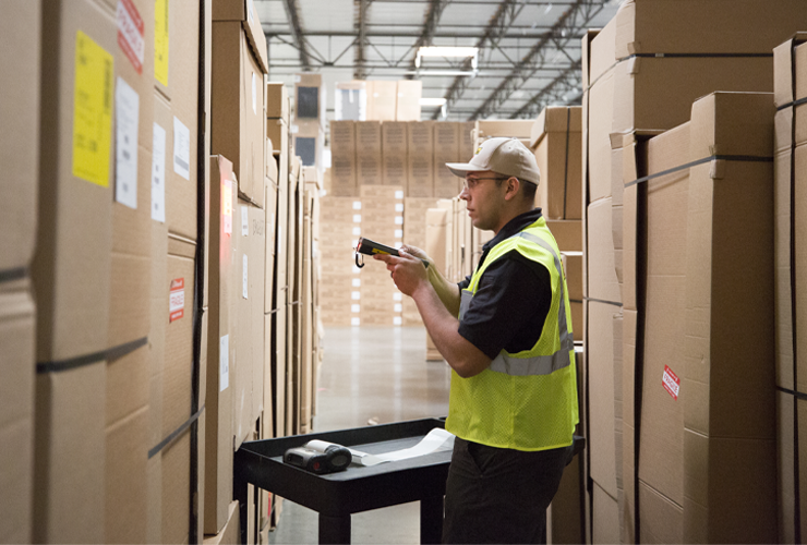 Warehouse worker organizes boxes