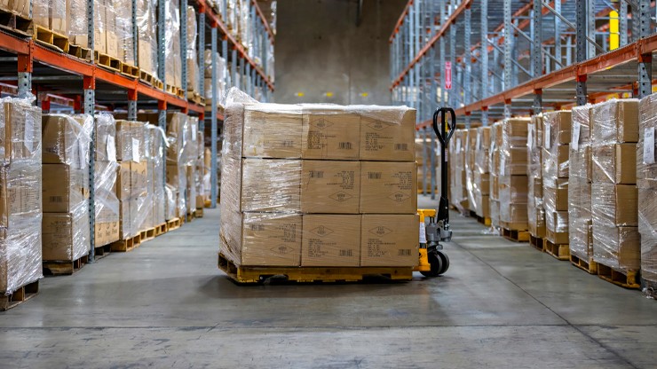 pallet of boxes on a pallet jack in a warehouse
