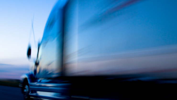 blurred image of tractor trailer